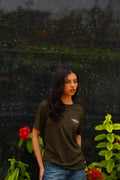 Girl wearing essentials blend army green t-shirt.