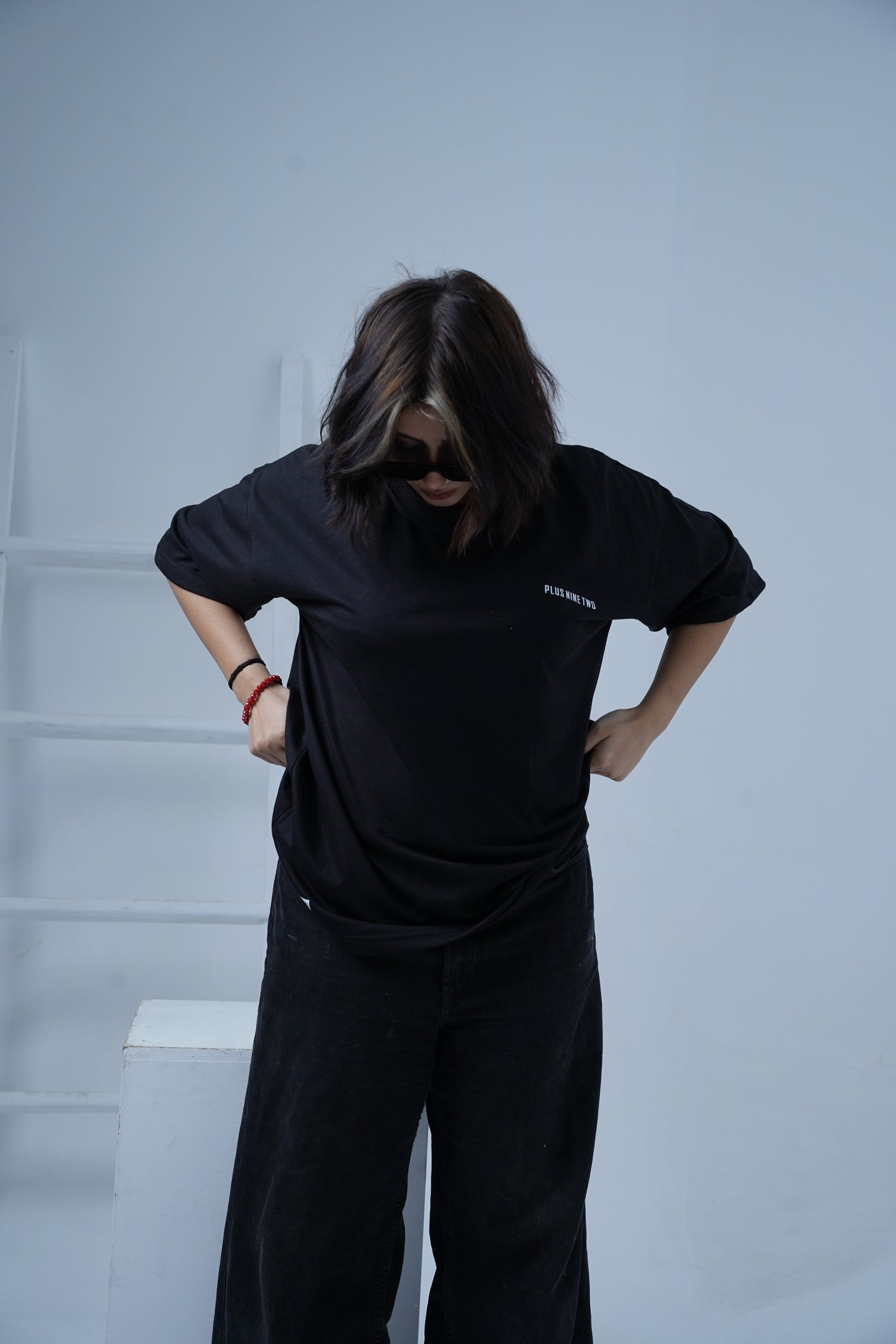 Person wearing a black outfit against a white background