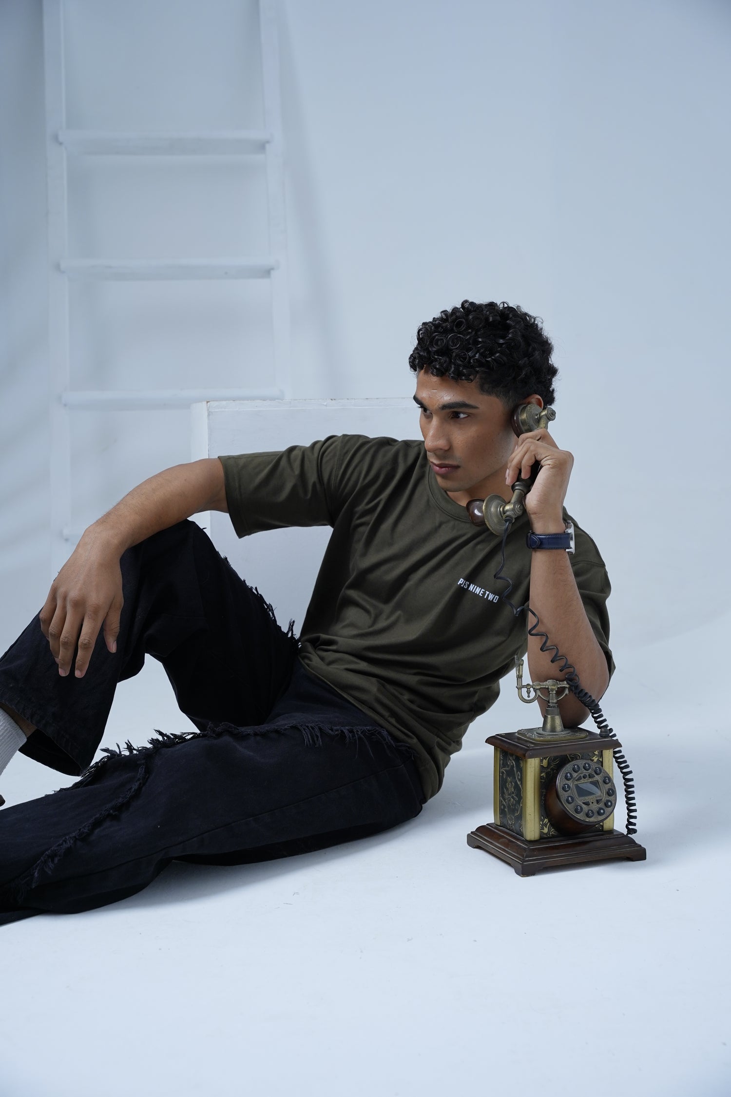Person holding a vintage-style phone against a white background