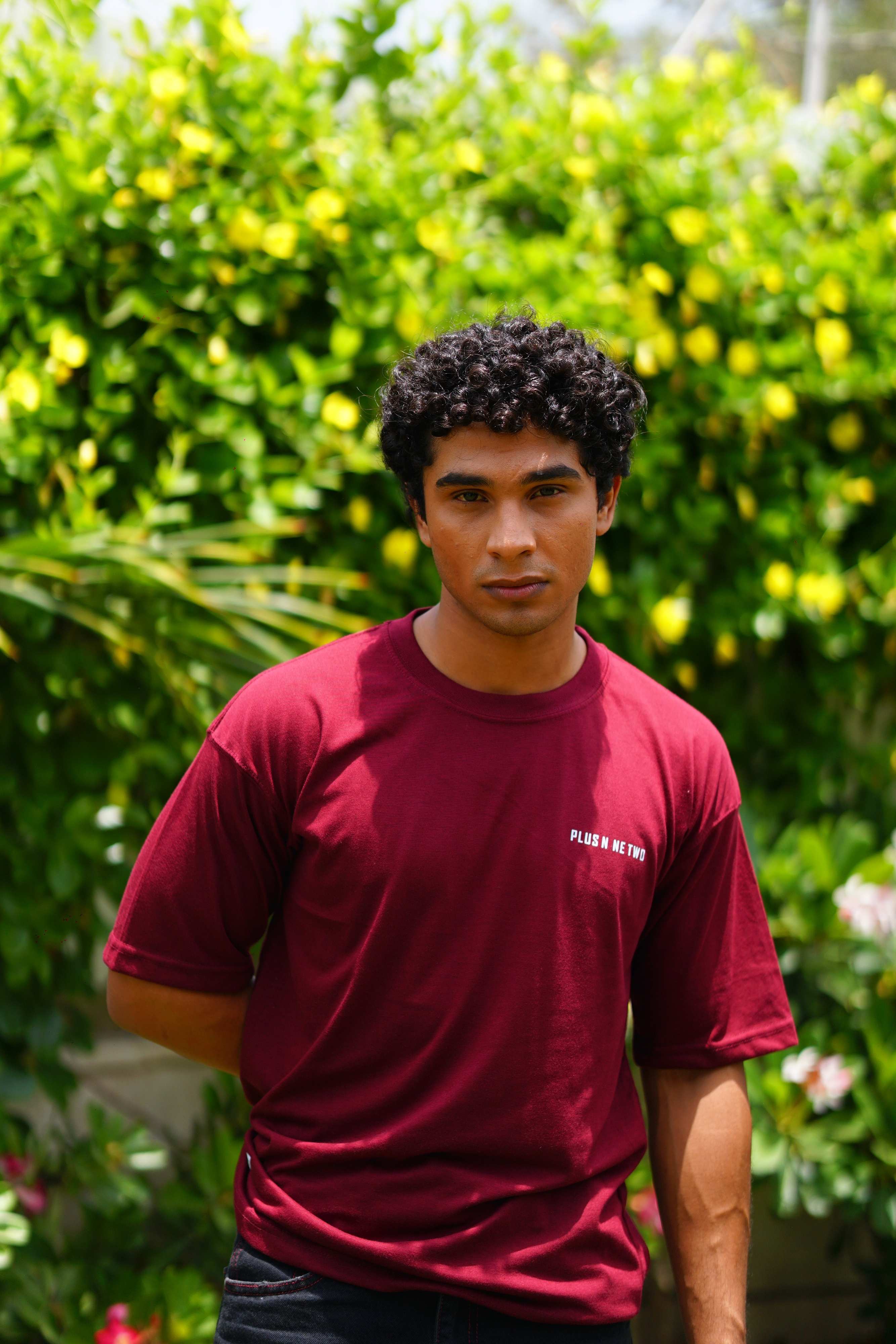 Front view of male model wearing Ajrak Maroon Essentials Dropshirt by +92 Clothing
