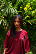 Front view of female model wearing Ajrak Maroon oversized dropshirt for women