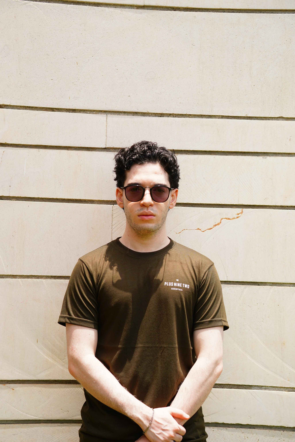 Front close-up of Men’s Army Green Essentials Blend T-Shirt with +92 logo