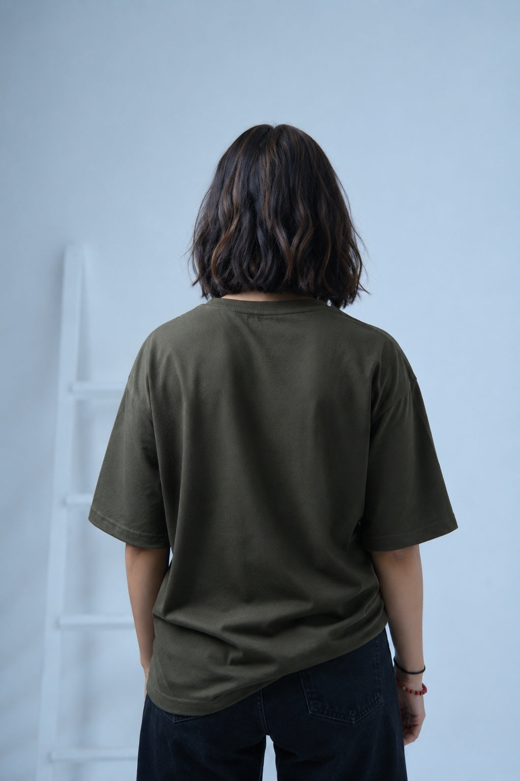 Women facing opposite wearing essentials army green oversized t-shirt by Plus92 Clothing.