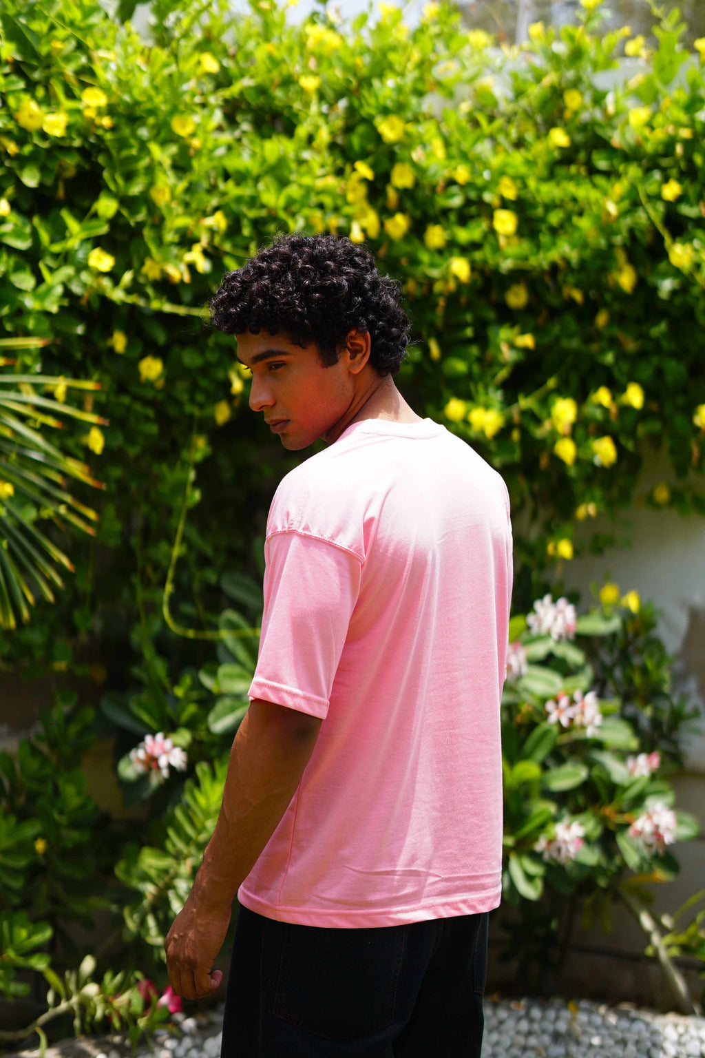 Men’s Baby Pink Essentials Dropshirt back view in garden setting