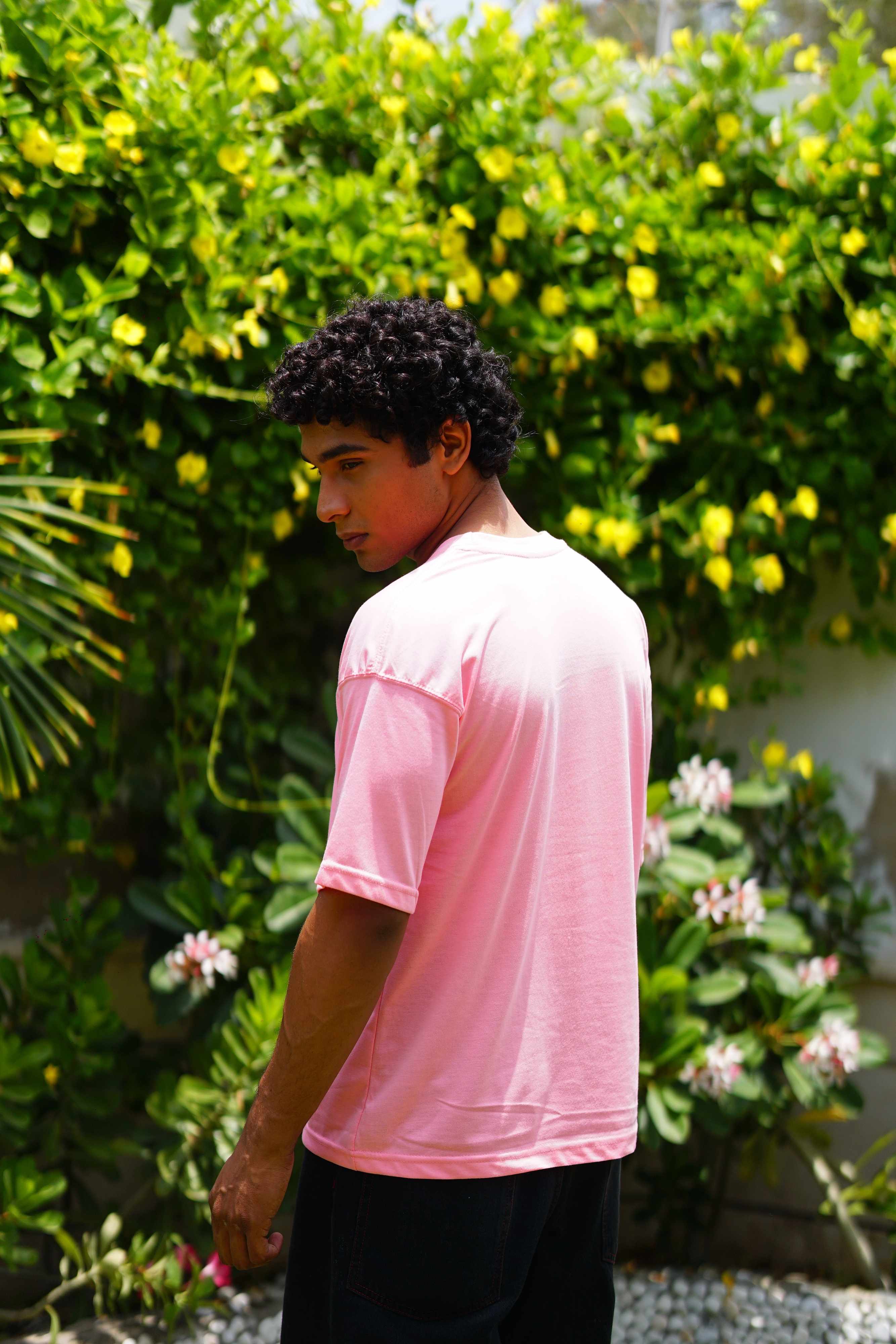 Men’s Baby Pink Essentials Dropshirt back view in garden setting
