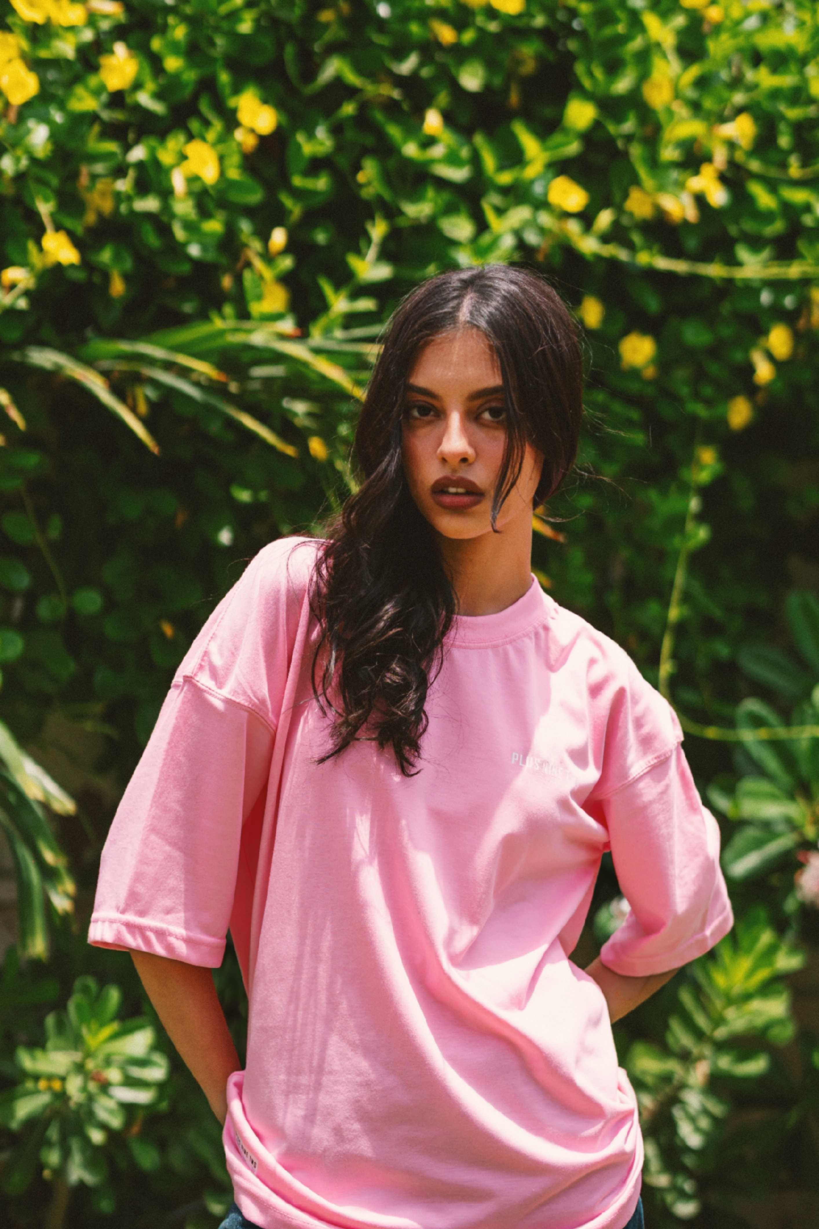 Women’s Baby Pink Essentials Dropshirt front view in garden setting