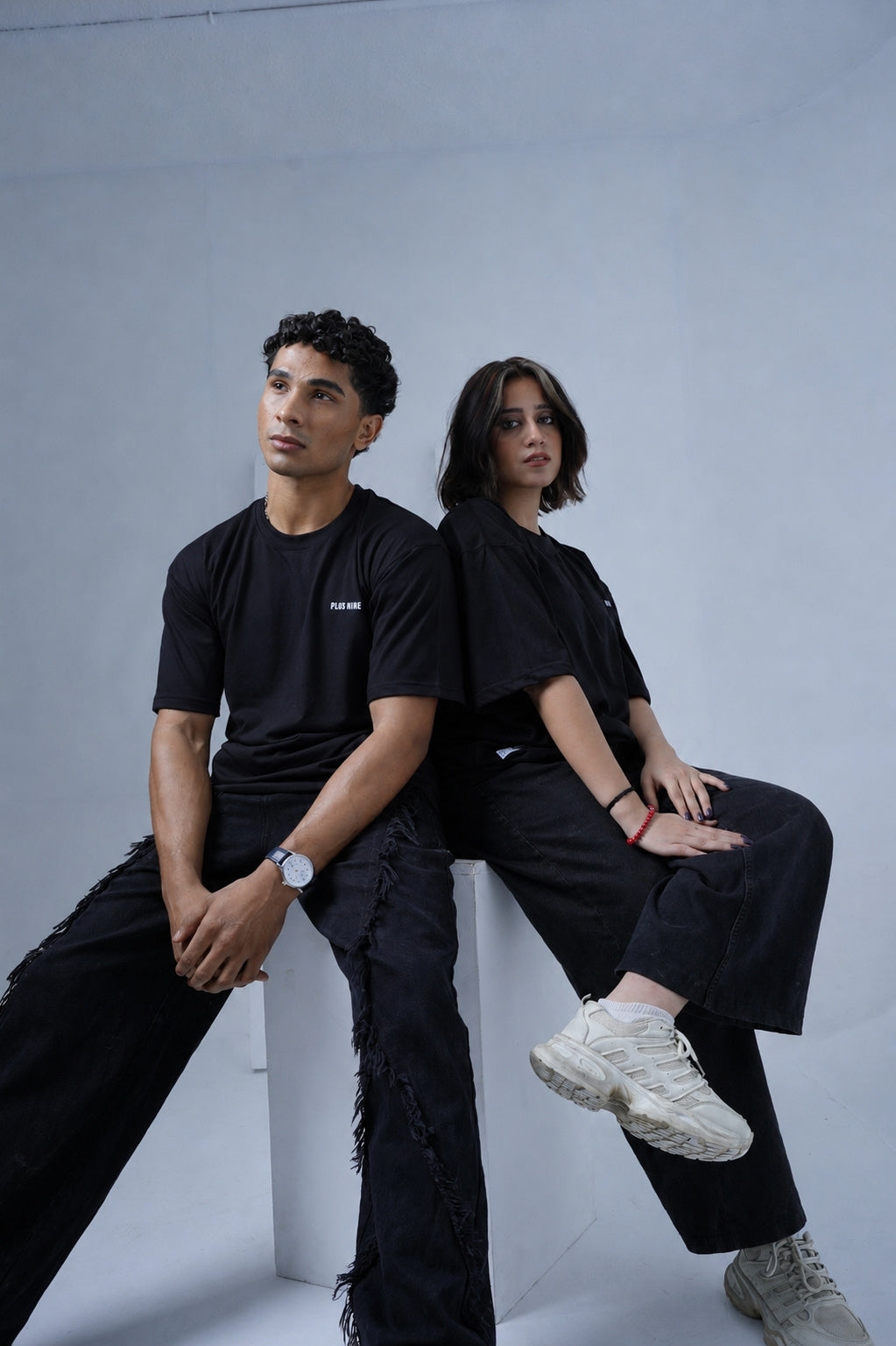 Male and female models wearing Black Essentials Dropshirts by +92 Clothing