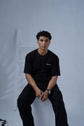 Front view of male model wearing Black Essentials Dropshirt for men by Plus Nine Two