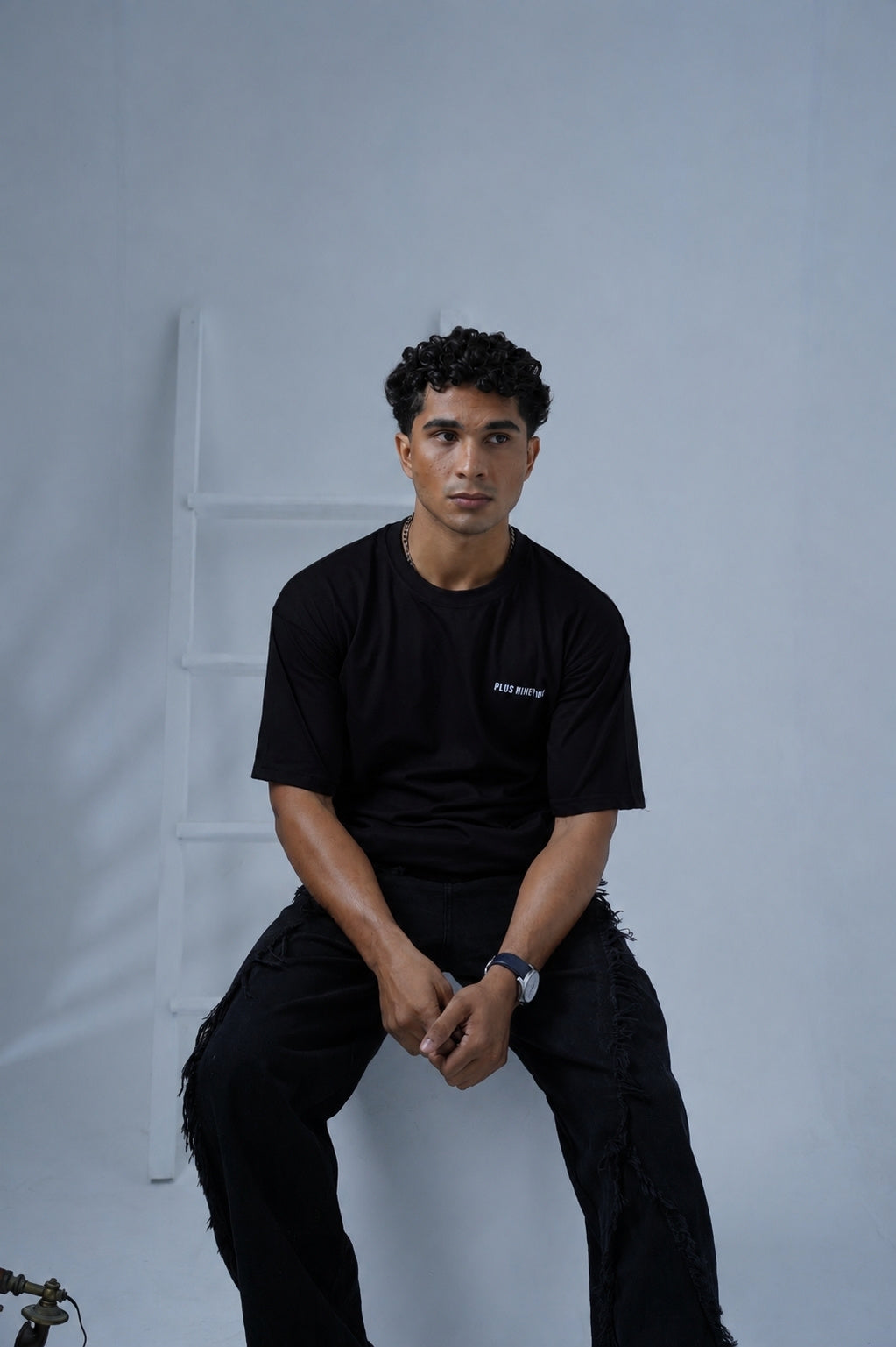 Front view of male model wearing Black Essentials Dropshirt for men by Plus Nine Two