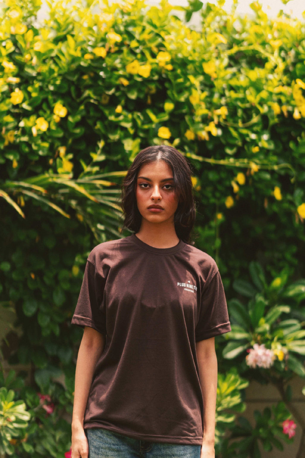 Front view of Women’s Karak Brown Essentials Blend T-Shirt in garden photoshoot