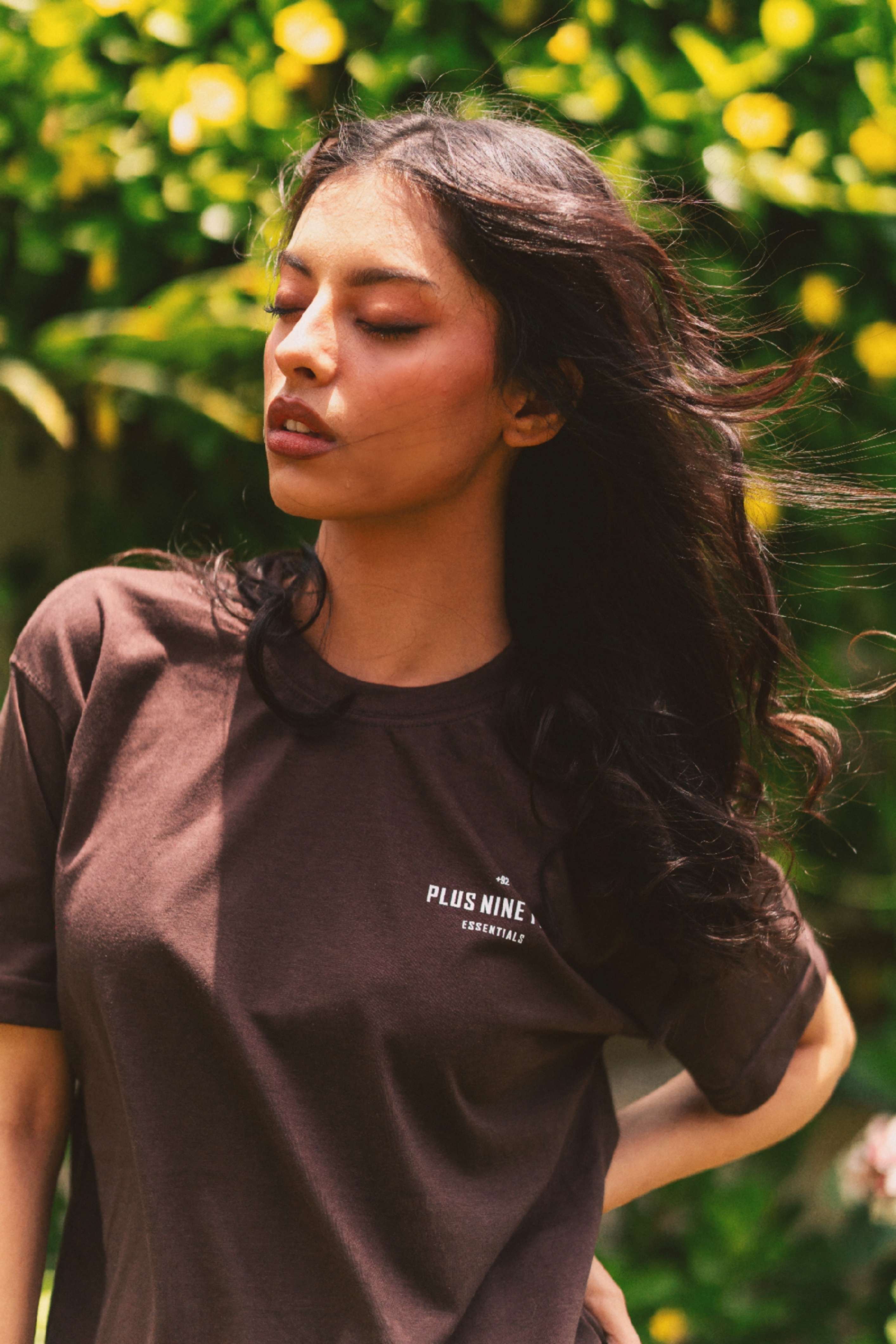 Women’s Karak Brown Blend T-Shirt close-up portrait in garden setting