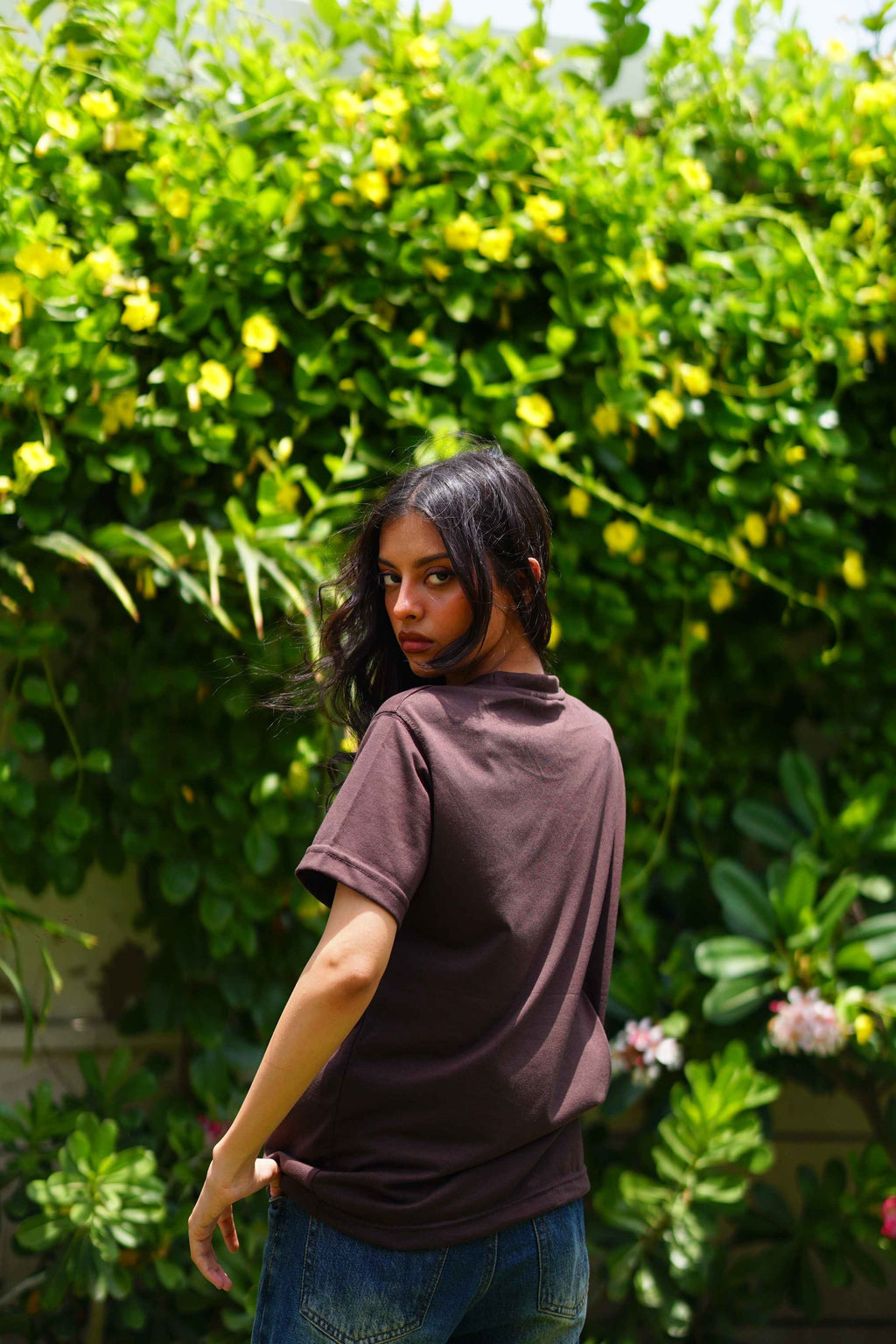 Back angle of Women’s Karak Brown Essentials Blend T-Shirt with denim