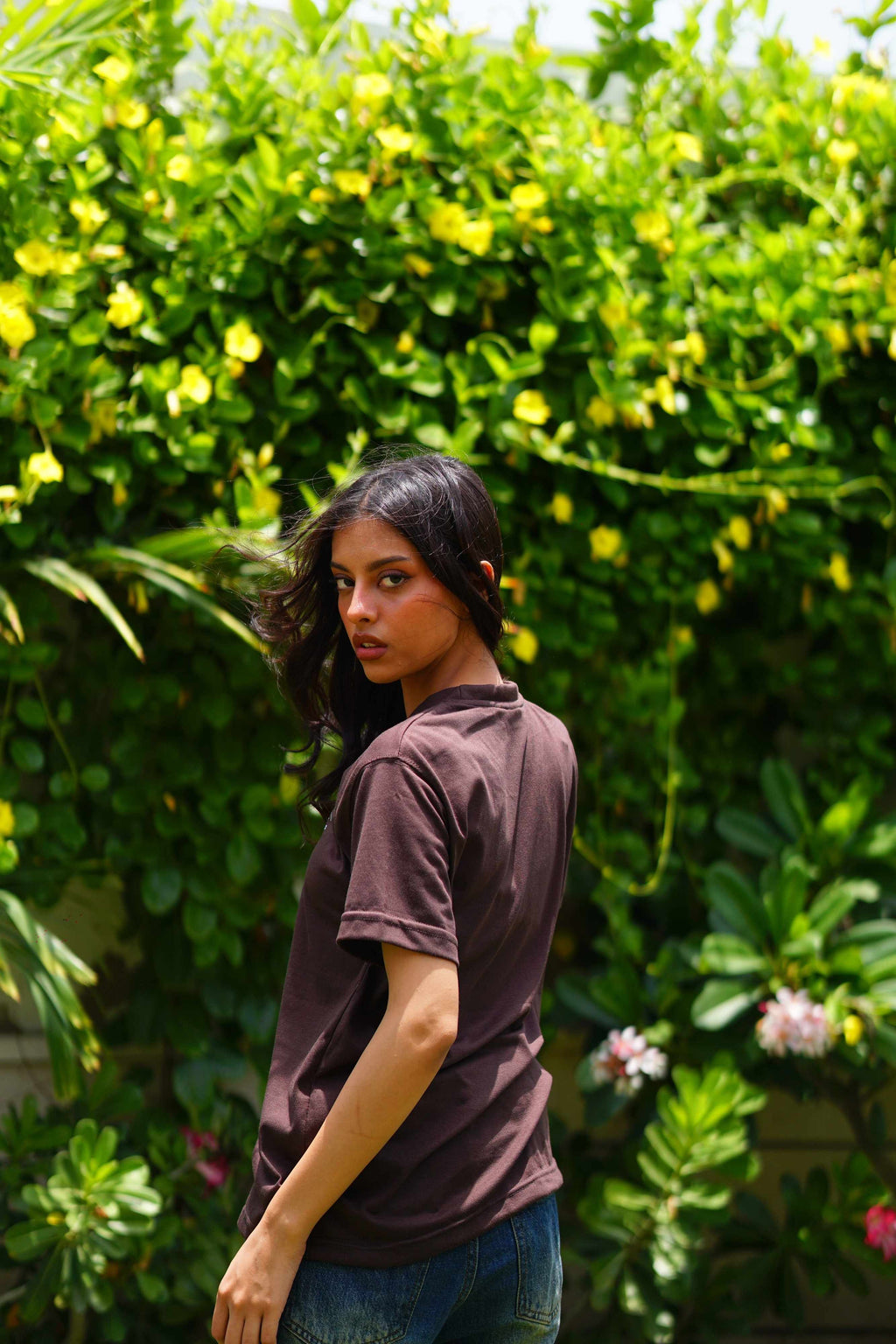 Back view of Women’s Karak Brown Essentials Blend T-Shirt in outdoor greenery