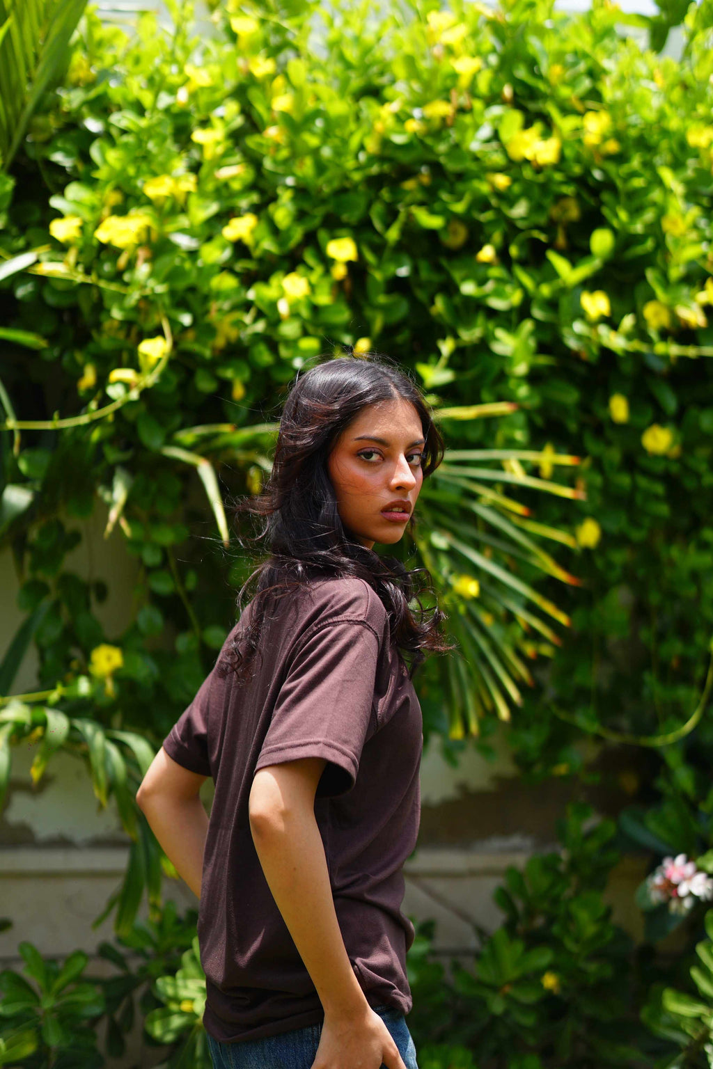 Women’s Karak Brown Blend T-Shirt side profile in garden photoshoot