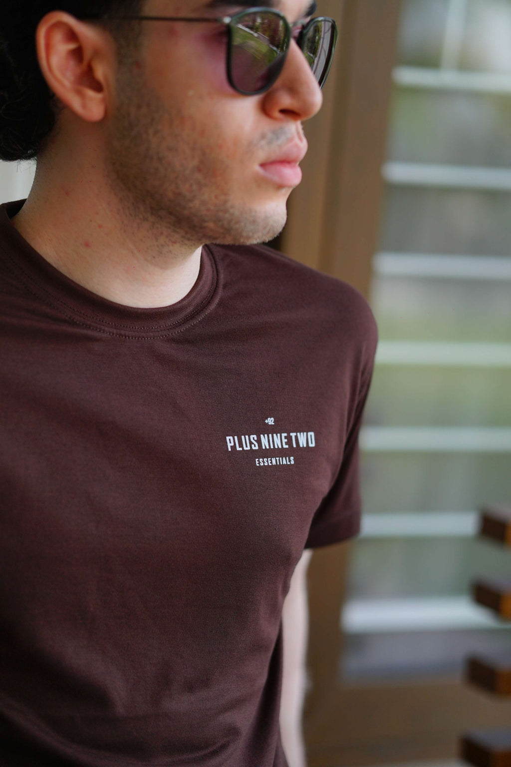Karak Brown Men’s Blend T-Shirt close-up with sunglasses and logo