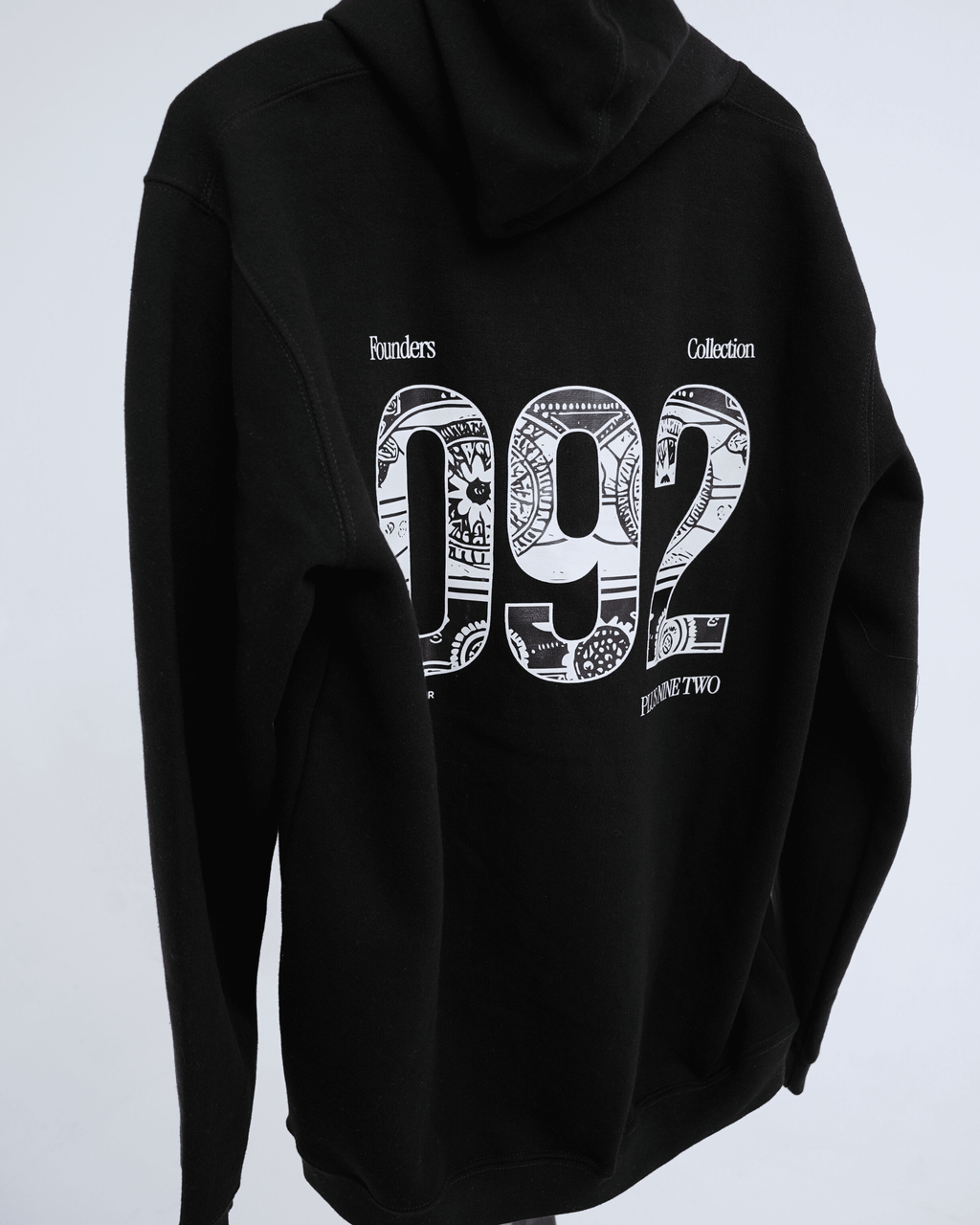 Black founders hoodie with white '092' design on a light gray background