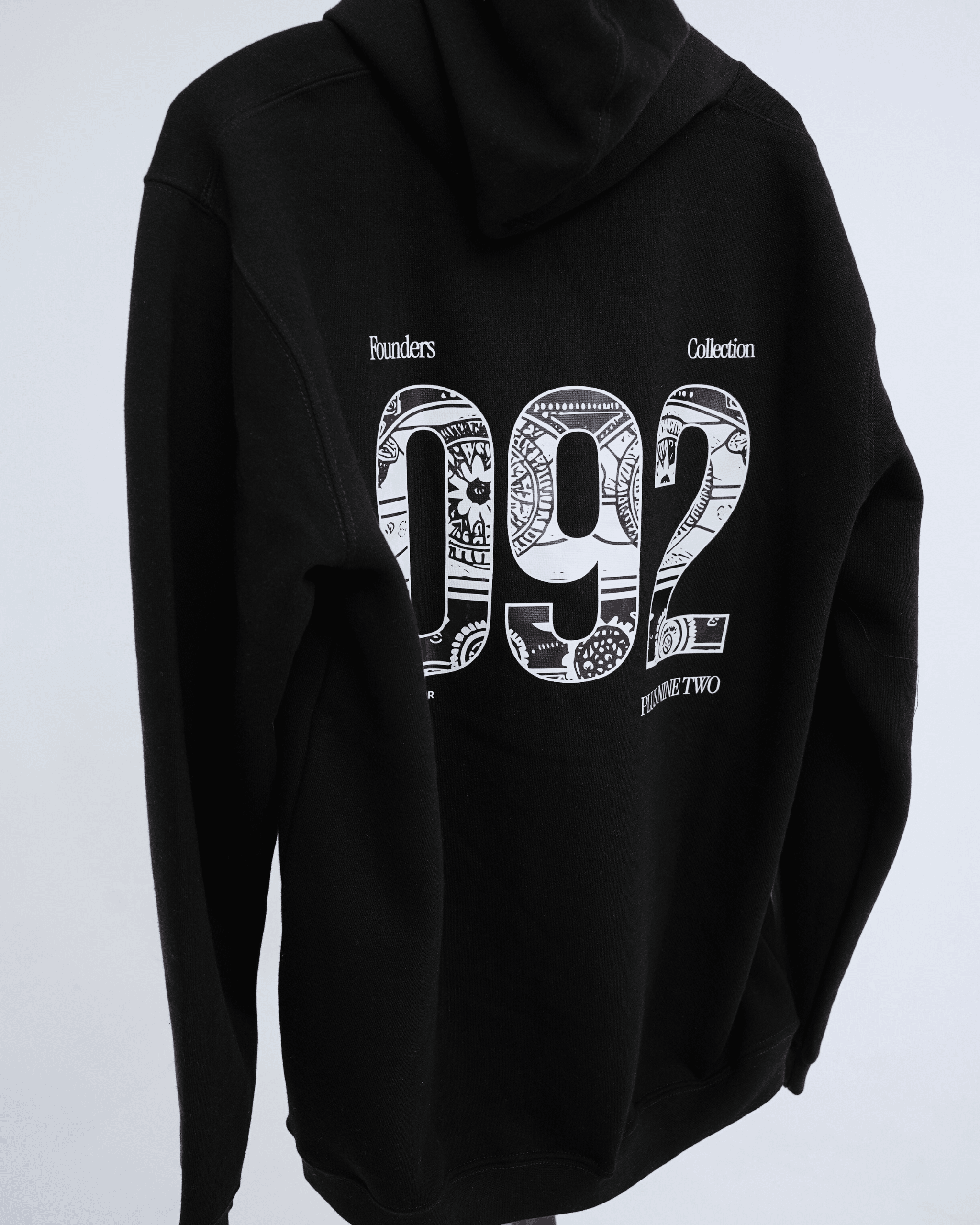 Black founders hoodie with white '092' design on a light gray background