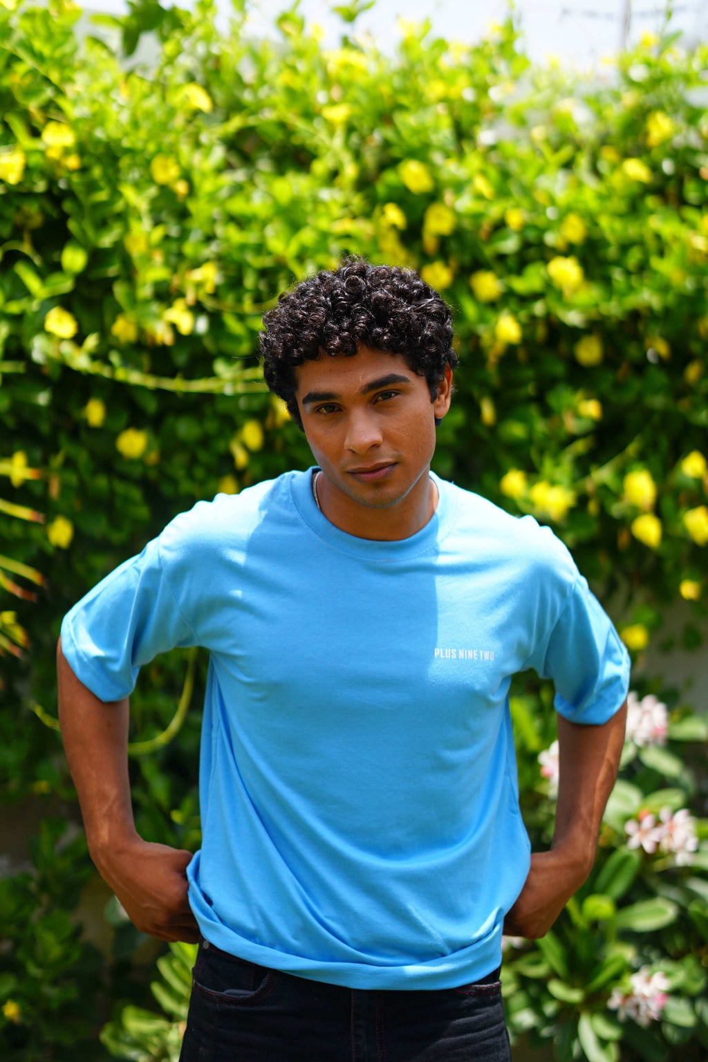 Male model wearing K2 Cloud sky blue Essentials Dropshirt in outdoor lifestyle shot