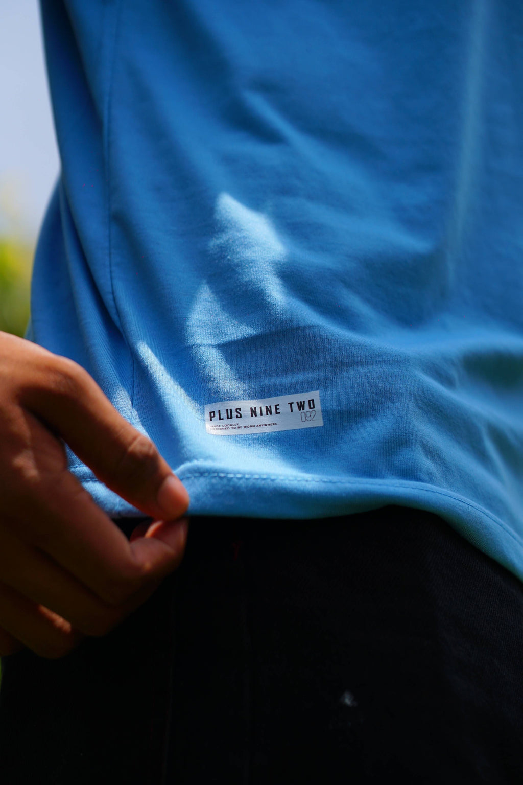 Close-up of Plus Nine Two hem label on K2 Cloud sky blue Essentials Dropshirt