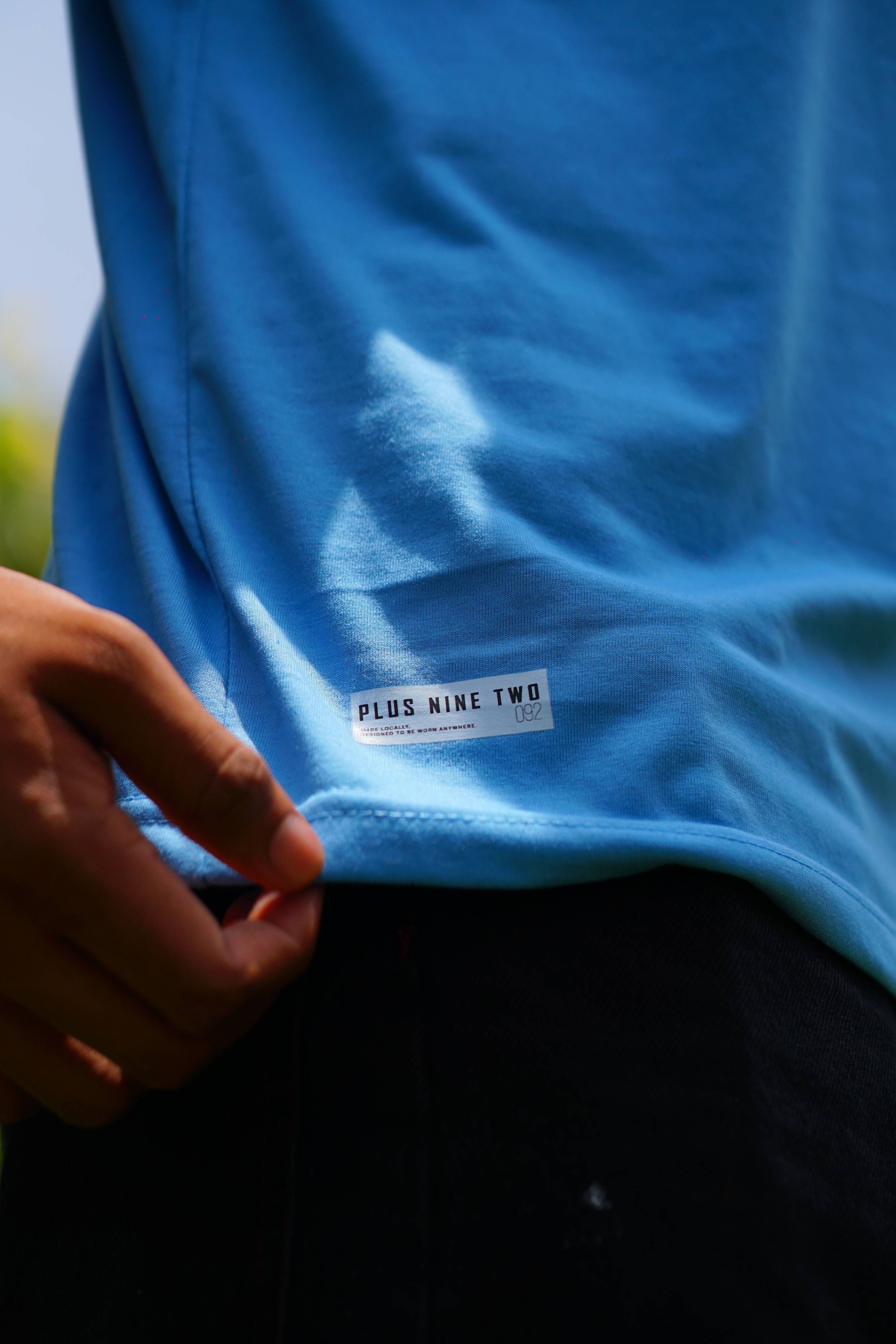 Close-up of Plus Nine Two hem label on K2 Cloud sky blue Essentials Dropshirt