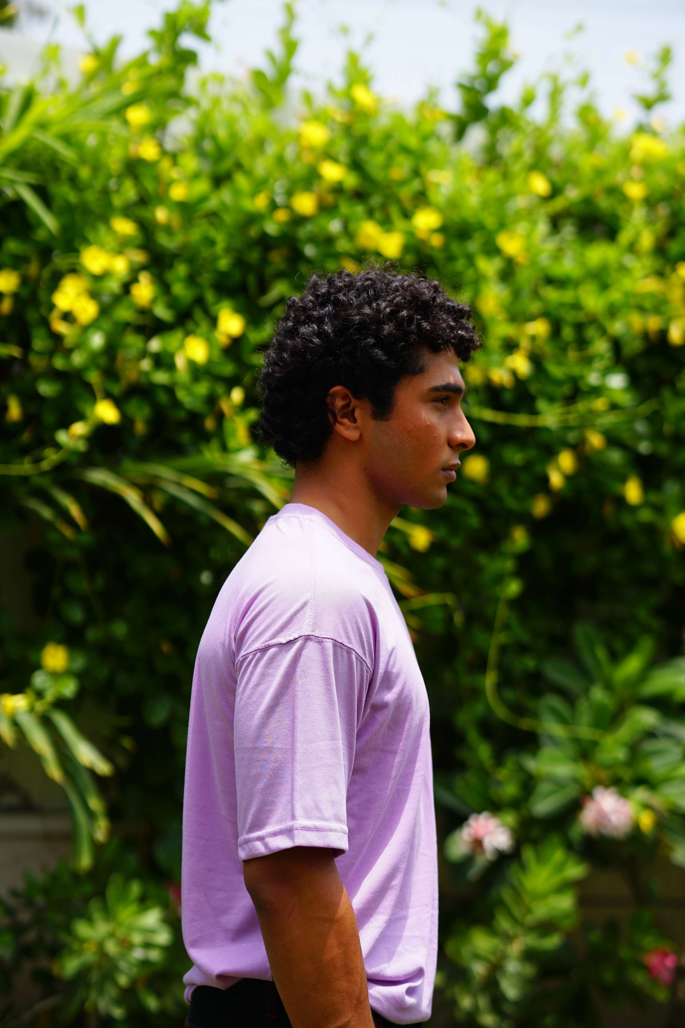 Side profile of male model wearing Lahore Lilac Essentials Dropshirt by Plus Nine Two