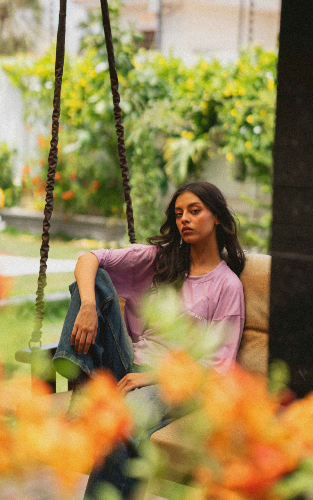 Women’s Lahore Lilac Essentials Dropshirt seated on swing in garden