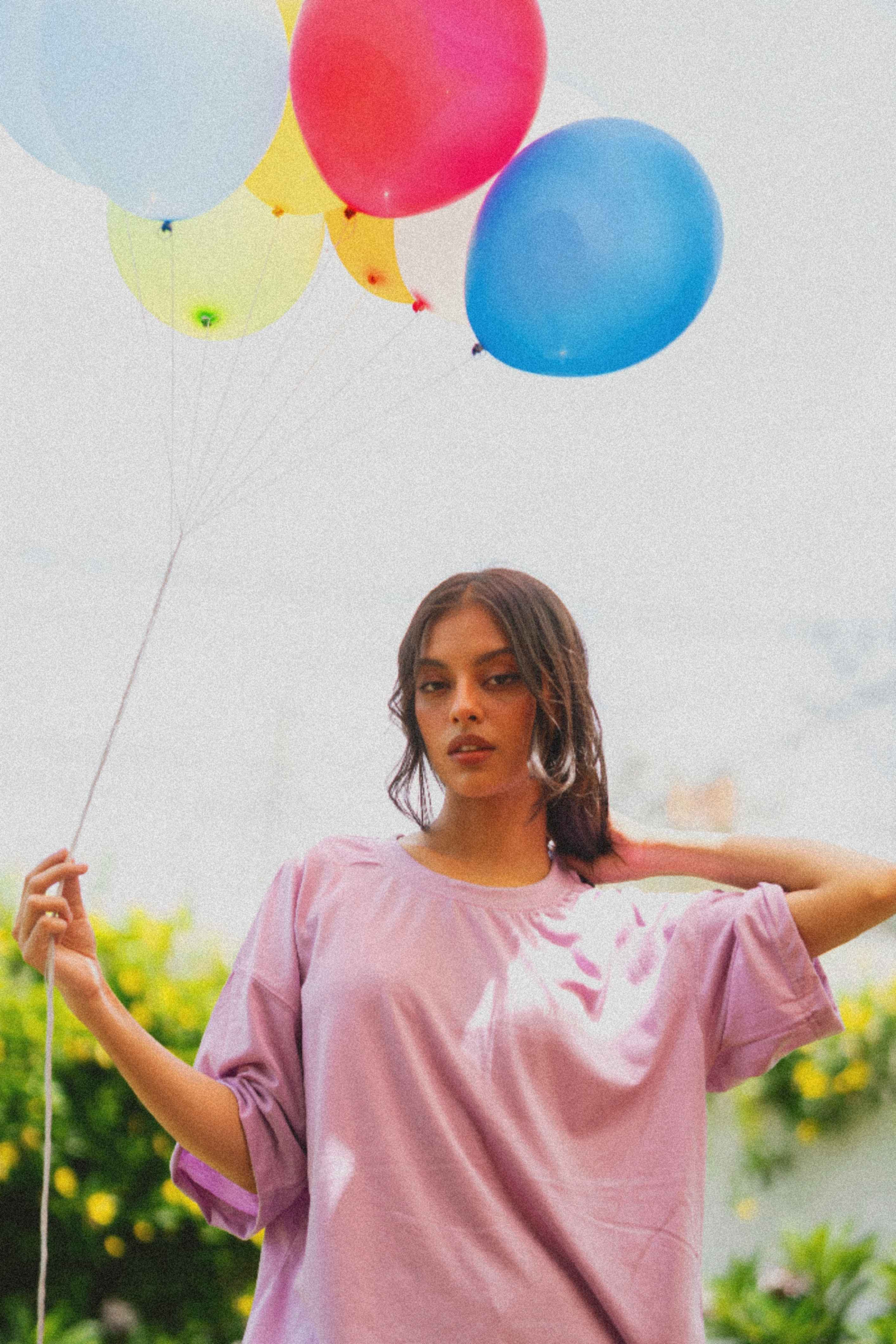 Women’s Lahore Lilac Essentials Dropshirt holding balloons outdoors
