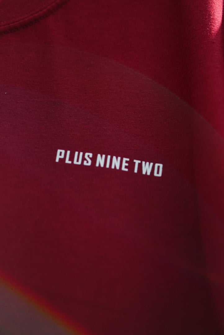 Close-up of Ajrak Maroon Women's Essentials Drop Shirt with the text 'PLUS NINE TWO' printed in white on the chest.