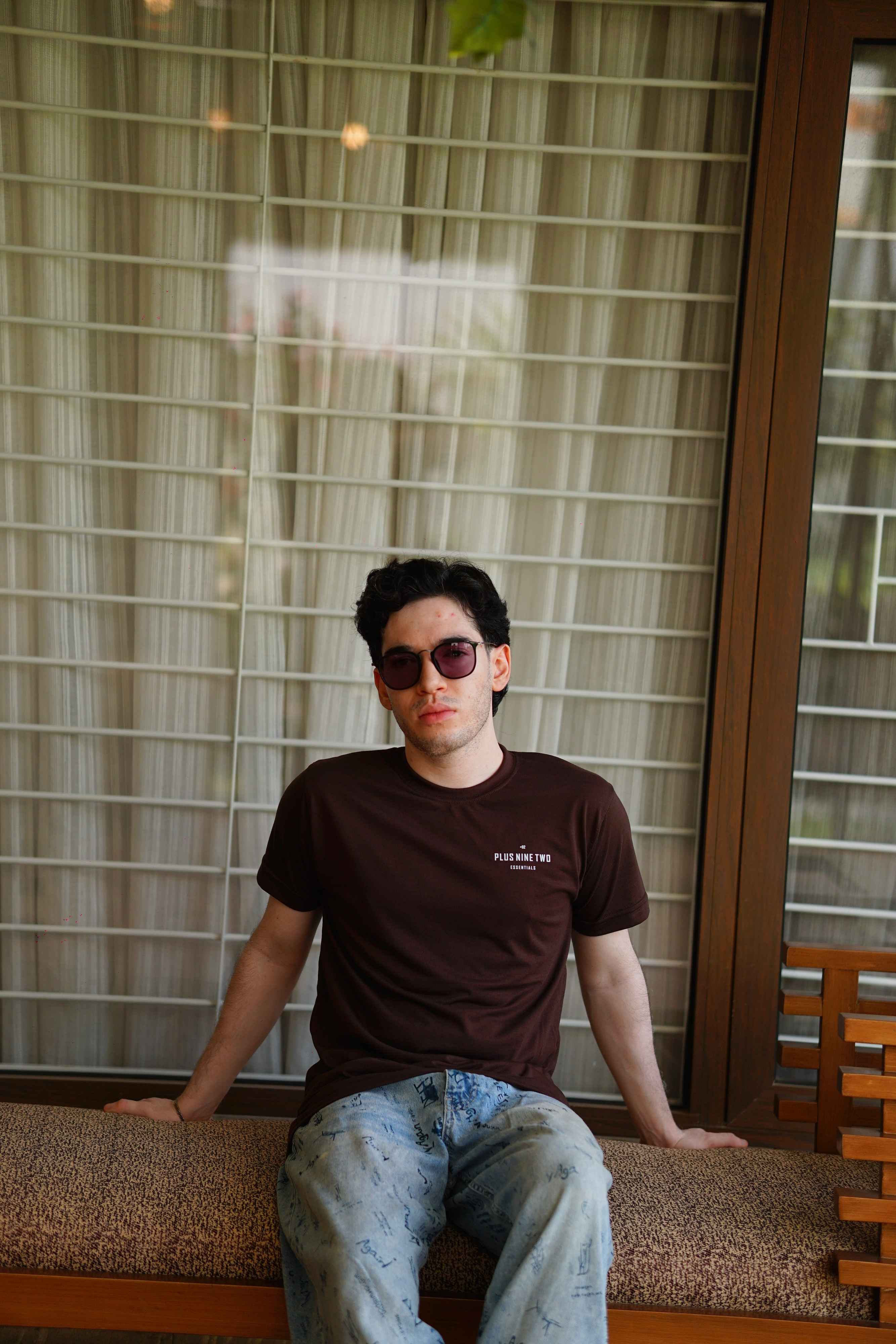 men sitting and posing wearing a plus92 ajrak brown blend t-shirt.