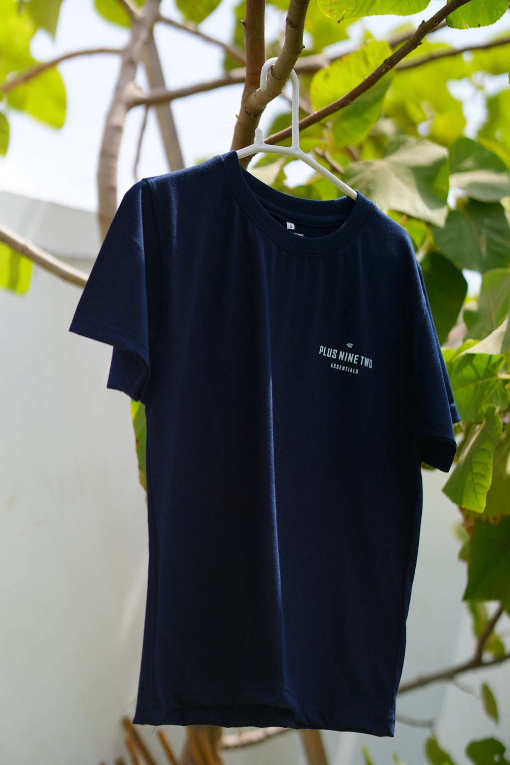 Indus Navy Blue Essentials Blend T-Shirt hanging on a tree branch