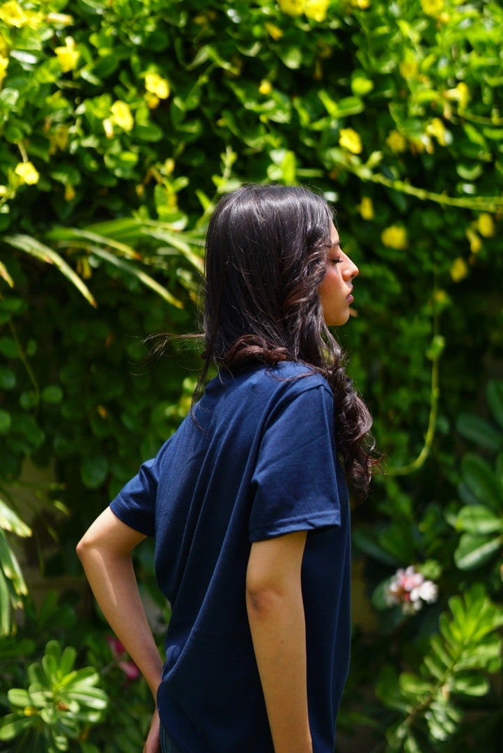 Girl wearing essentials indus navy blue blend t-shirt showing sleeve and back fitting.