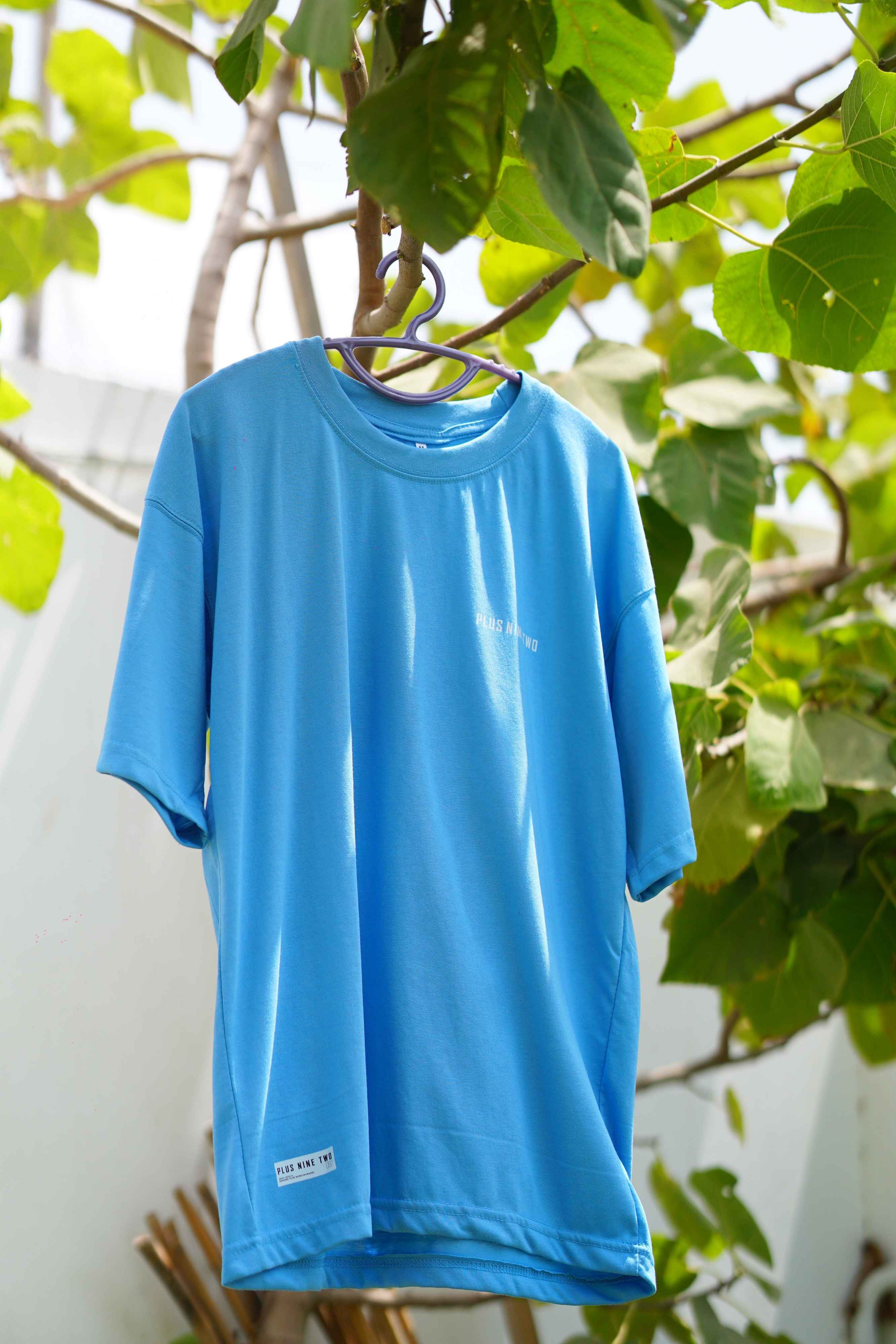 K2 Cloud Sky Blue Essentials Dropshirt hanging on tree branch product photo