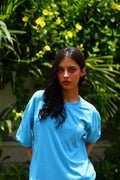 Women’s K2 Cloud Sky Blue Essentials Dropshirt front view in garden photoshoot