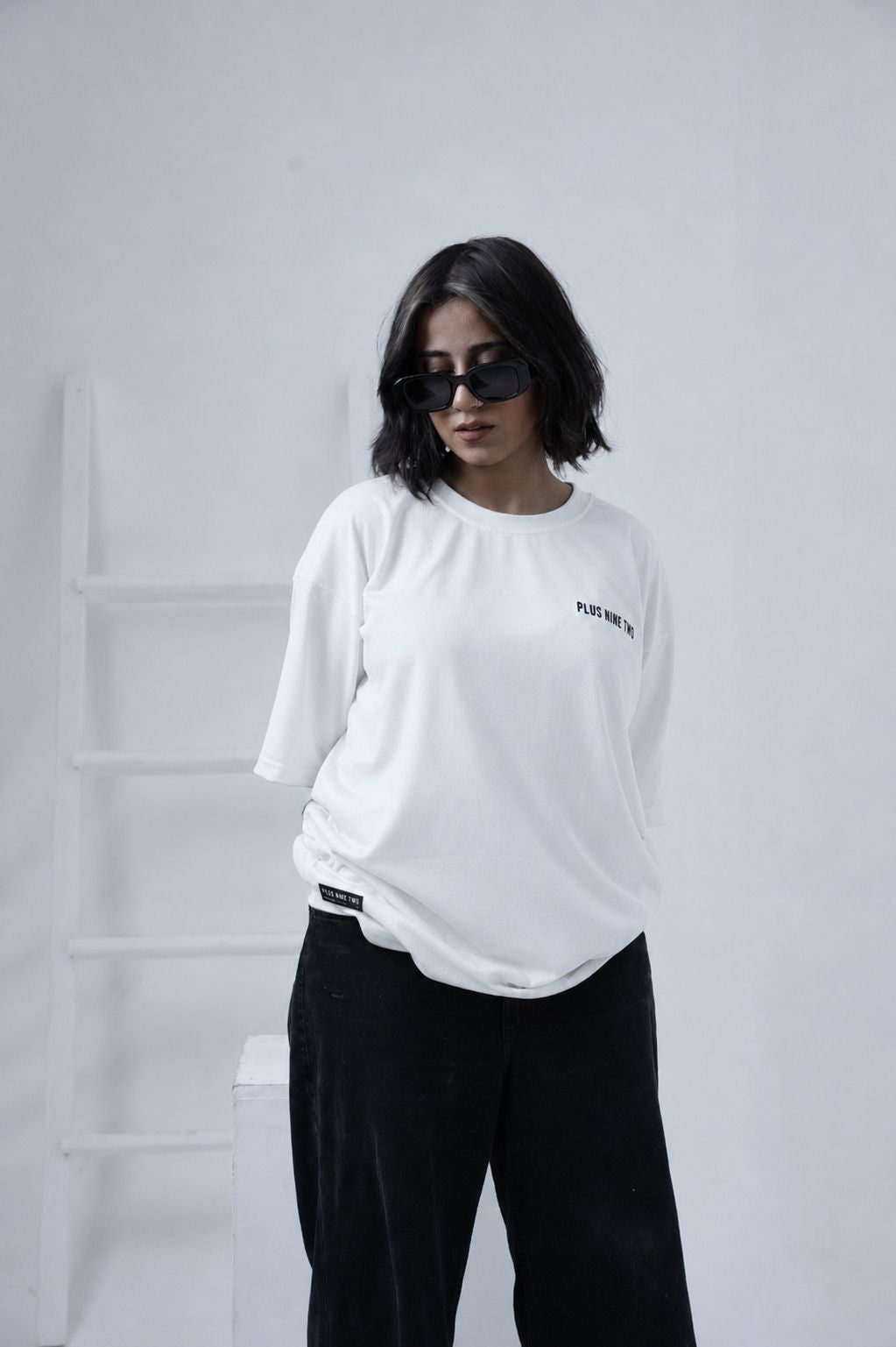 Women posing wearing essentials white oversized t-shirt by Plus92 Clothing.