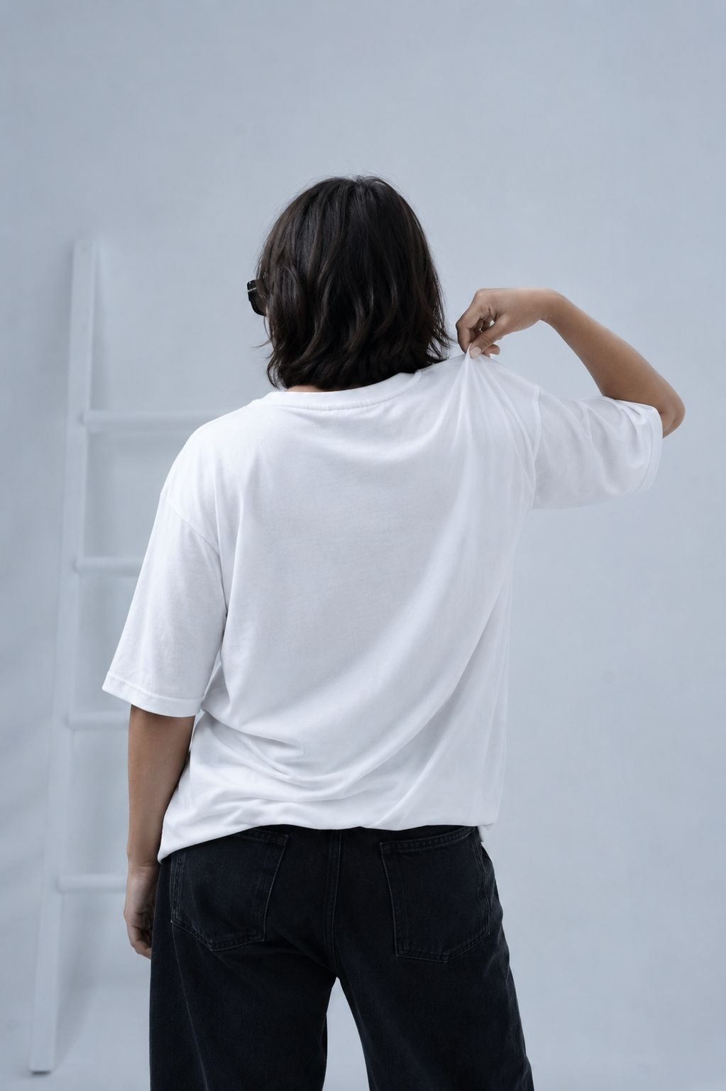Women facing opposite wearing essentials white oversized t-shirt by Plus92 Clothing.