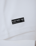 White Essential Dropshirt with Signature Printed Tag of Plus Nine Two shown