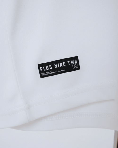 White Essential Dropshirt with Signature Printed Tag of Plus Nine Two shown