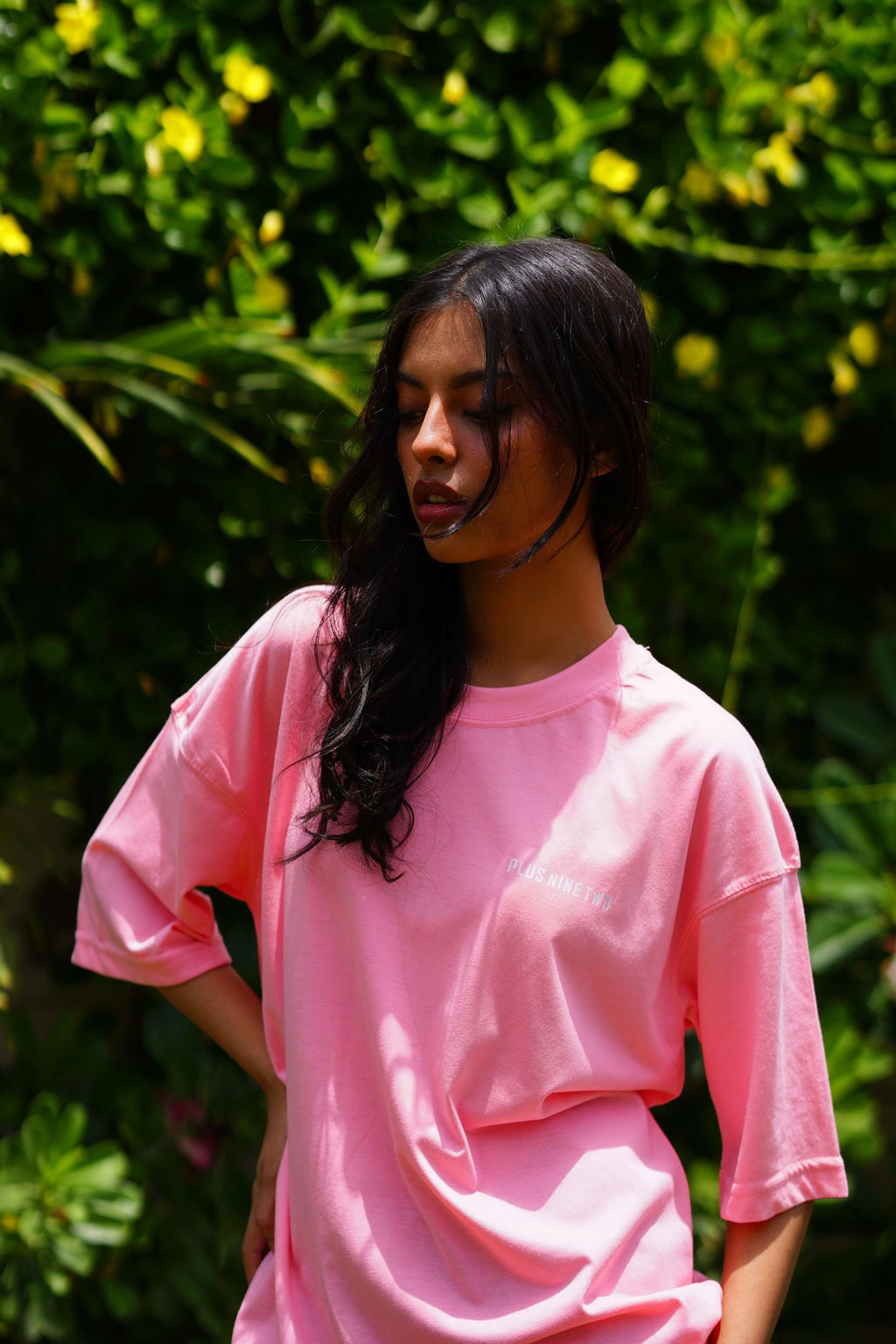Female model wearing Baby Pink Essentials Dropshirt women’s oversized t-shirt by +92 Clothing