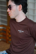 Close-up of man sitting, wearing karak brown men blend t-shirt with pocket print visible